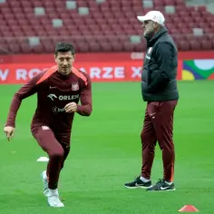 Robert Lewandowski w akcji, jego robert lewandowski statystyki są imponujące. Trener obserwuje trening.